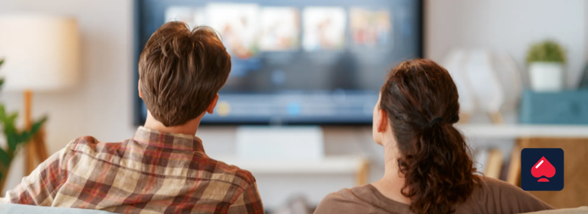 Image showing 2 people watching tv adverts adn wondering why they are seeing less gambling ads.